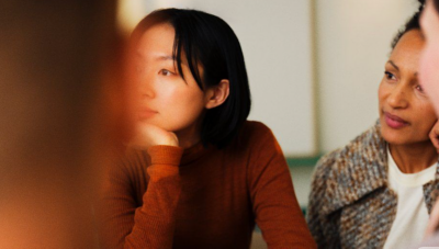 Close up of a laptop with blurry night lights background.