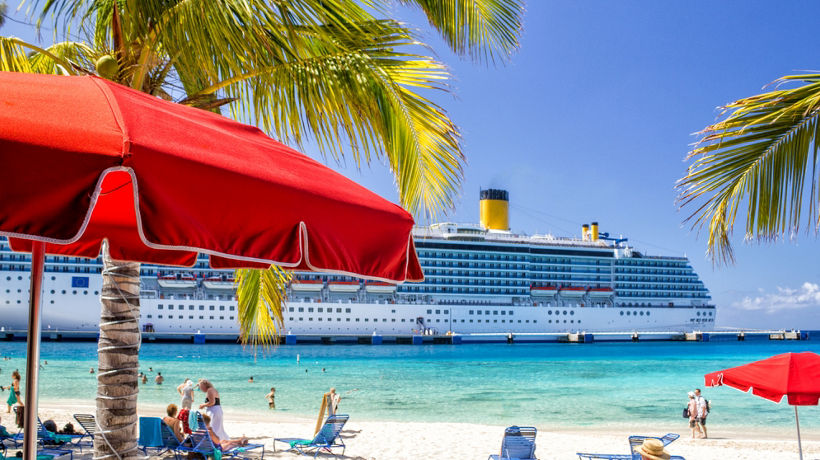 A beach with a cruise ship in the background.