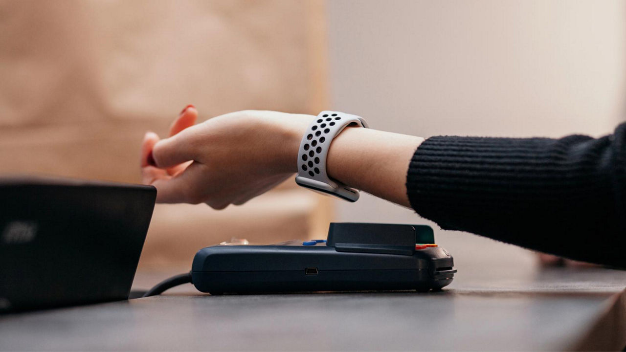 Customer scanning their smartwatch to pay