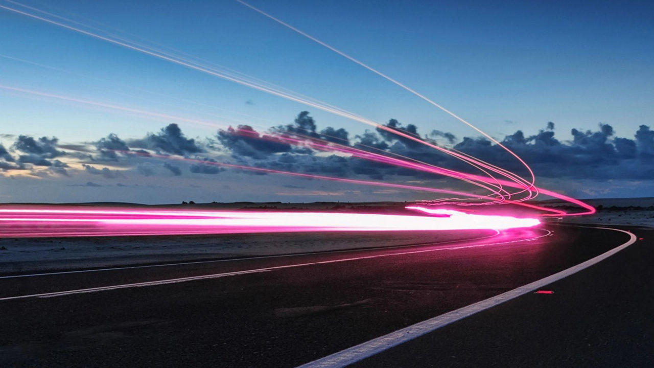 Light Trails On Road Against Sky