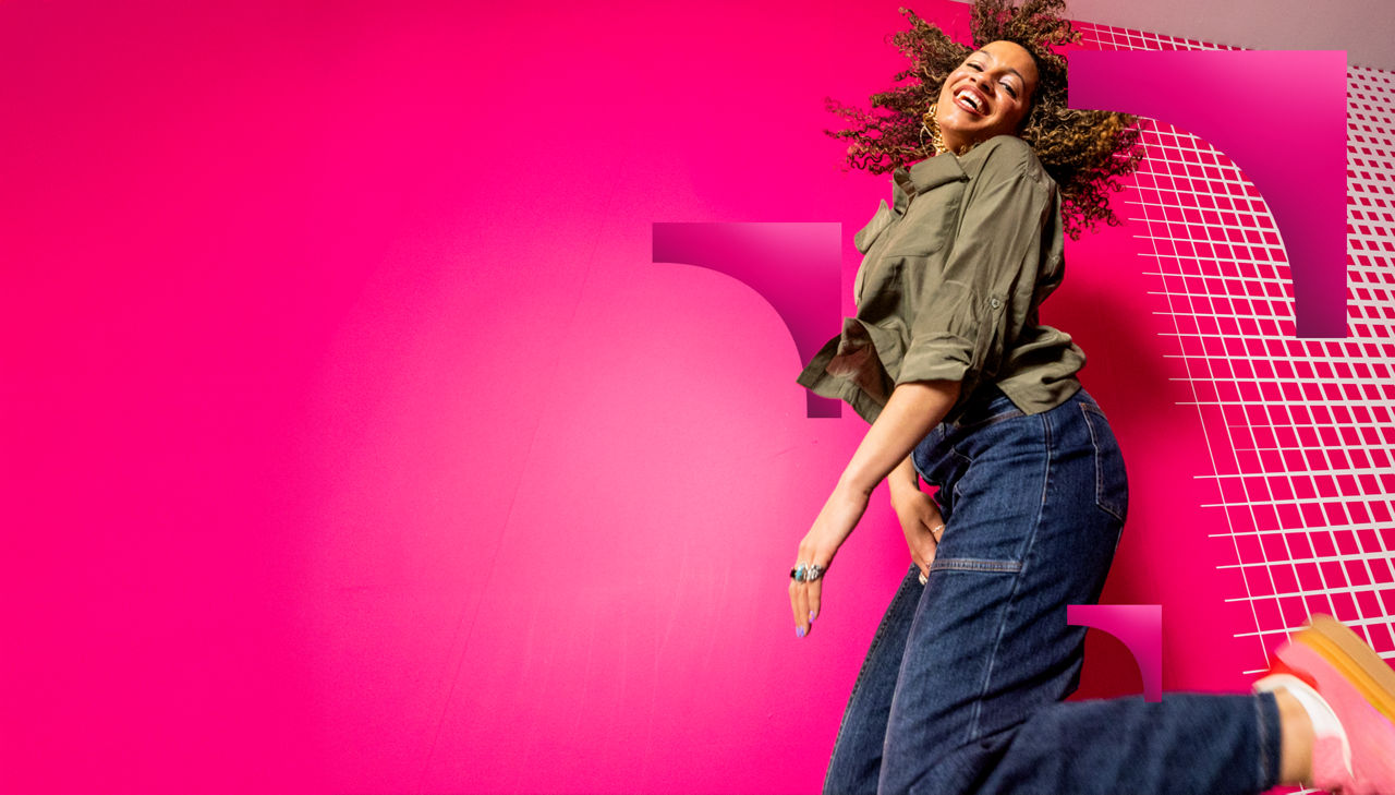 Happy woman jumping against vibrant magenta background