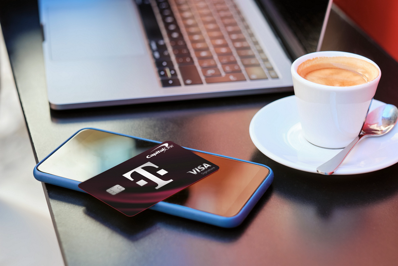 magenta background with white text and photo of T-Mobile Visa 