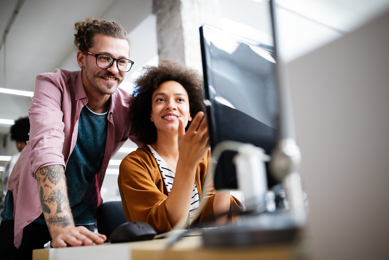 Male and female in front of computer