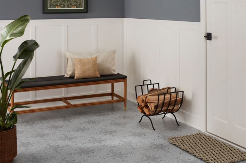 This elegant entryway features an ornate black patterned floor.