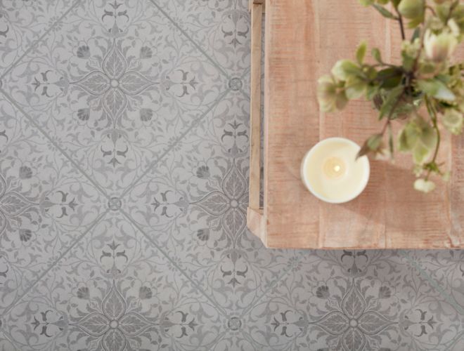 Patterned gray porcelain tile features a delicate tone-on-tone floral design that adds interest to this entryway floor without overwhelming the space or competing with other design elements.