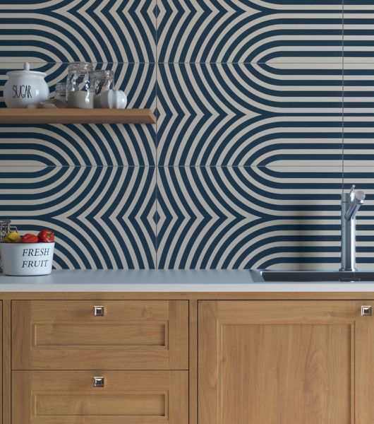 Kitchen sink and counter with a blue and off-white tile wall.