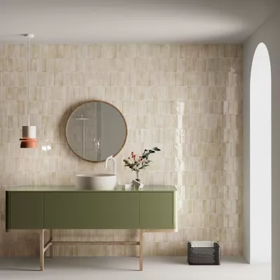 A serene bathroom featuring glossy beige handmade-look subway tile. 