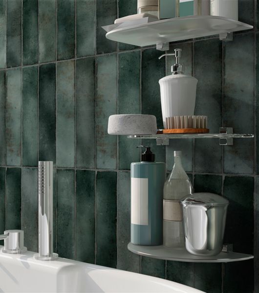 This bathroom backsplash features jade-colored subway tiles in varied green tones that have been installed vertically to create a distinctive look