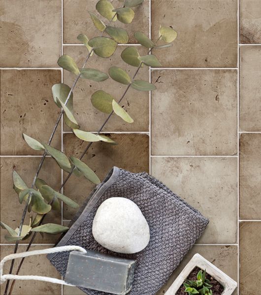 Aerial shot of a light-brown square porcelain tile patio floor.