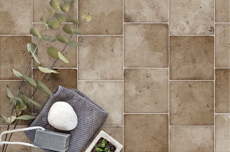 Aerial shot of a light-brown square porcelain tile patio floor.