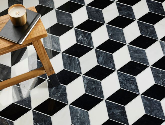 Black, grey and white hexagon marble floor with small wood table.