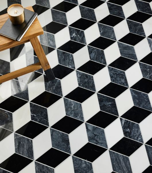 Black, grey and white hexagon marble floor with small wood table.