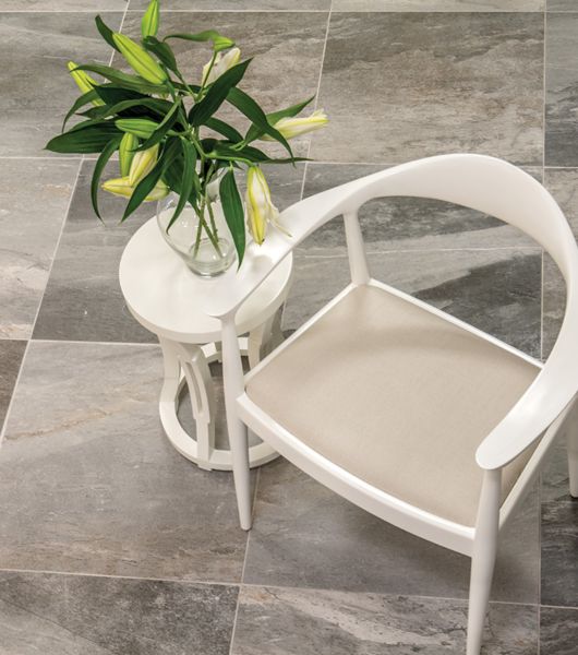 Large-format square porcelain tile in rich black, charcoal and cream hues.