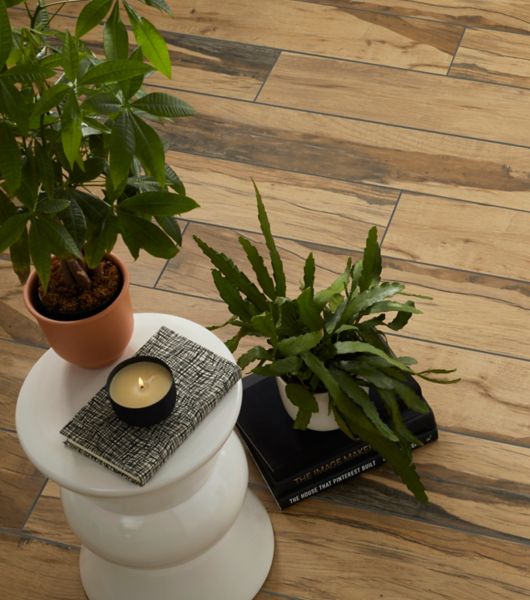 Living space with wood-look tile plank flooring with high-contrast graining in dark and light browns. The overall look emulates tropical wood floors.