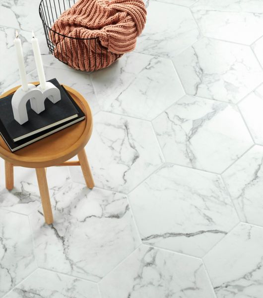 Living space with floor covered in 20-inch marble-look hexagon tile. Tile color is white, with veining patterns in shades of medium and dark gray.