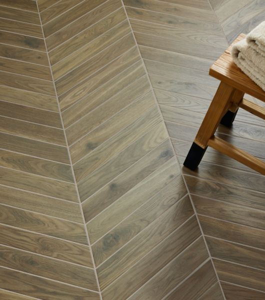 Brown wood-look chevron floor tiles arranged in rows