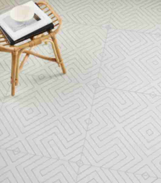 Large-format white with black geometric patterned tile floor with a small wooden table.