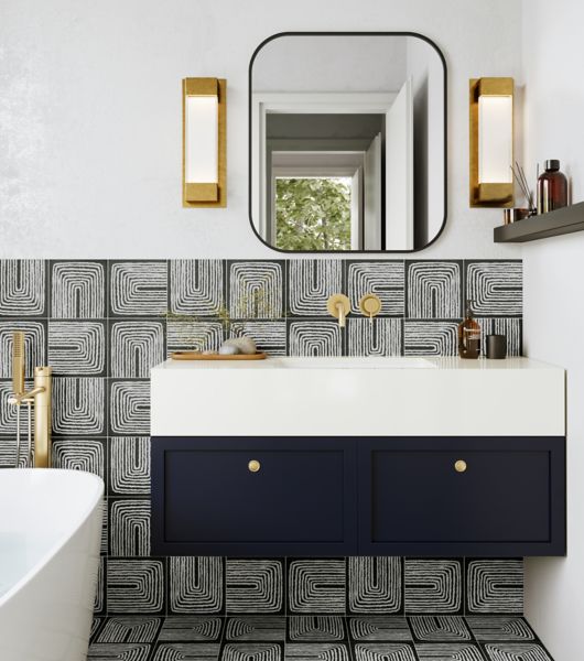 This chic modern bathroom features a black-and-white abstract-patterned tile on the floor and backsplash.