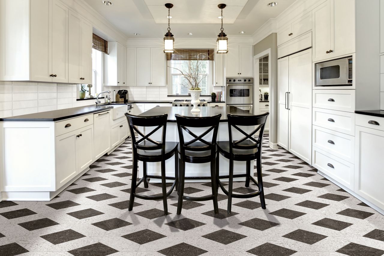 This bright open kitchen features a lapis with black tiled floor. 
