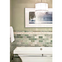 Thumbnail image of Bathroom area with Green tones and natural neutral tones of marble tile. Wainscotting has a subway tile with an onyx mosaic border and a marble profile that coordinates with the subway tile. A marble baseboard adds a custom feel.