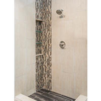 Thumbnail image of Walk in shower with ceramic wall tile ran vertically in a staggered pattern corner is clipped with a waterfall feature any music Zac tile also running vertically with recess shelves inserted shower pan is a large full wood tile curb area is natural start neutral tones and accenting from dark to light tones add depth dimension and some movement to the area.
