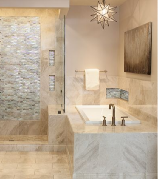 Bathroom area with natural marble throughout and a glass stria mosaic as accent in frame and niche.