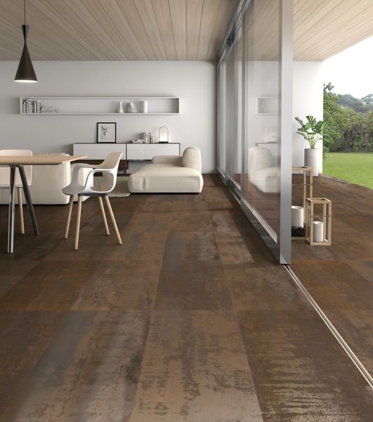 Indoor/outdoor patio area with porcelain floor tile in large profile stacked and warm tones and a metallic finish adding a industrial feel to this modern area.