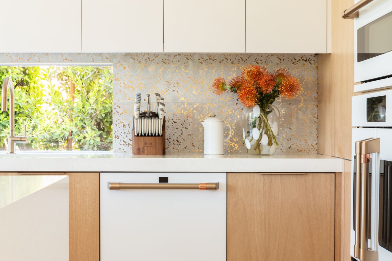 Chic kitchen with white and gold speckled tile backsplash.