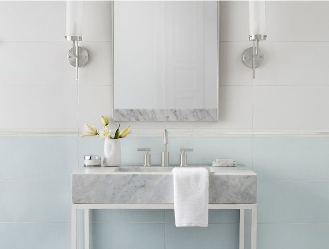 Lovely bathroom with subtly patterned blue and white tile.