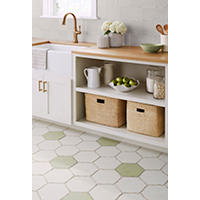Thumbnail image of Kitchen area tiled in ceramic tile on floors and walls floor tile is a hexagon in mostly white with sage green scattered throughout while tile is 6 by 6 square tiles in a plain white and one with a lace pattern I'll have natural edges. 