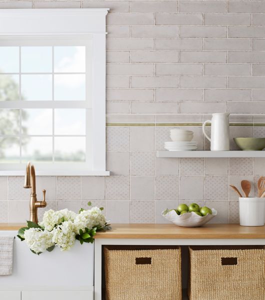 Kitchen sink and counters with a white tile wall