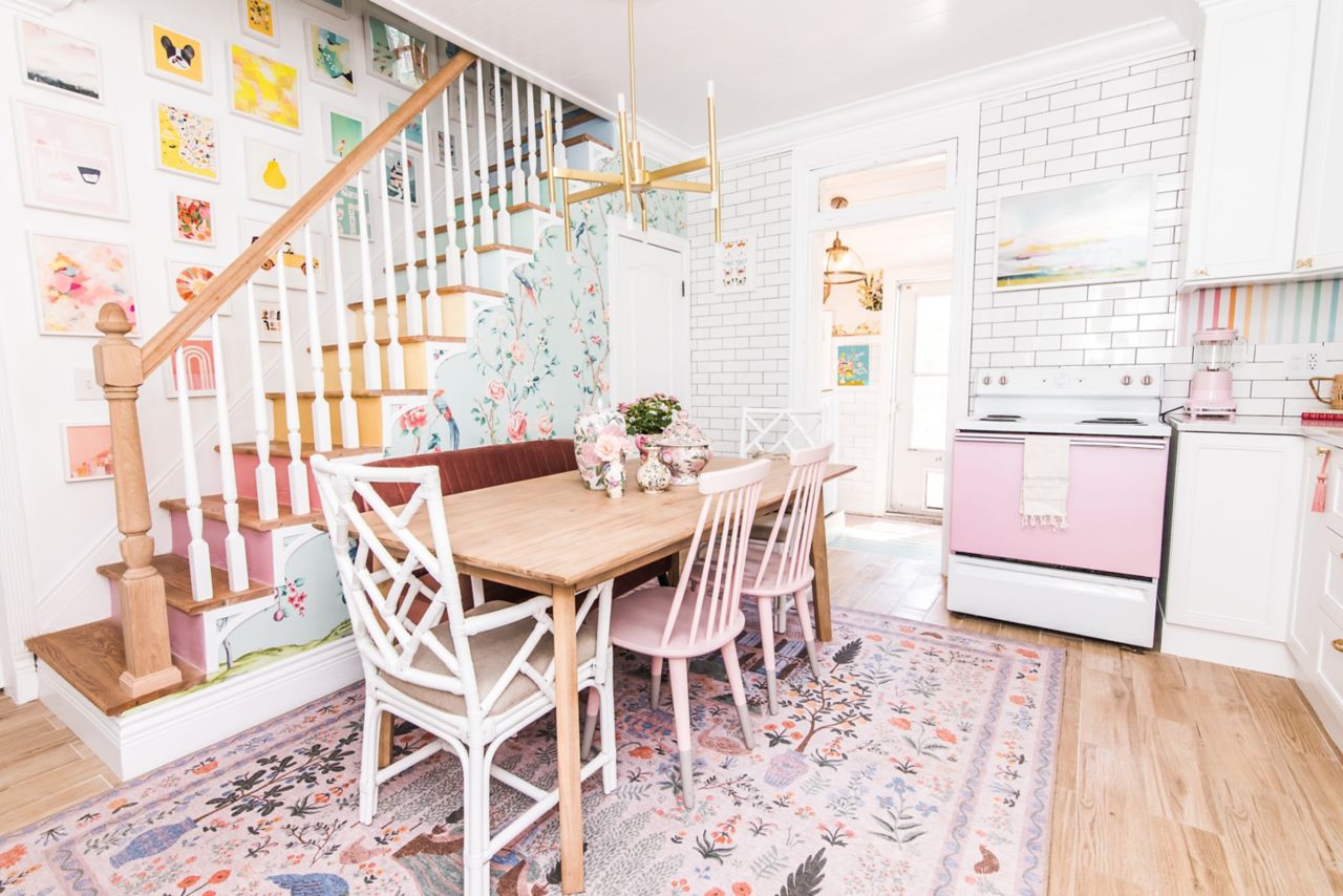 This bright, colorful kitchen features white subway tile backsplash and a wood-look porcelain tile floor. 