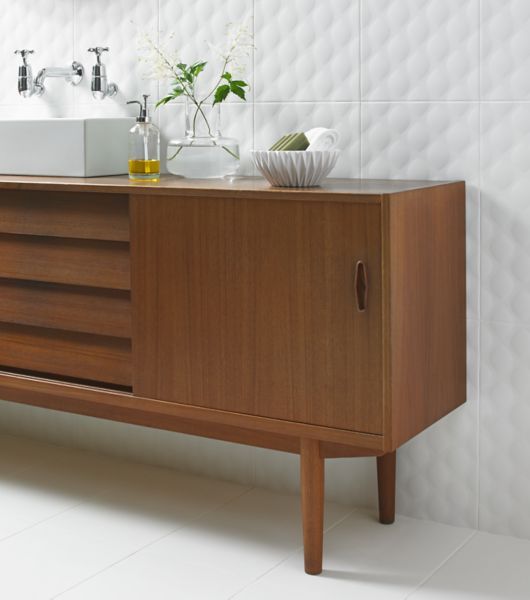 Modern bathroom vanity with white textured designer wall tiles.