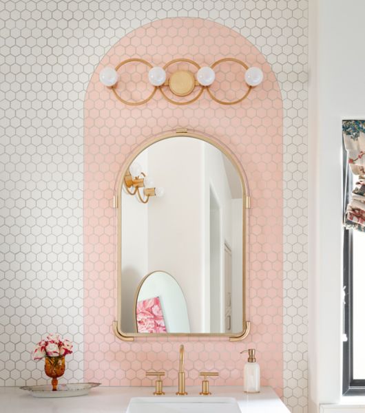 Bathroom with a white and pink arch hexagon tile backsplash.
