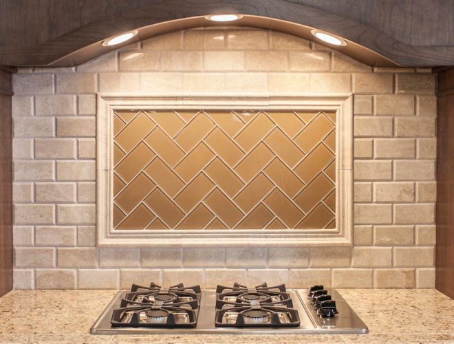 Beige subway tile on kitchen backsplash above stove.