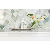 Thumbnail image of Bathroom vanity area with a innovative shape in soft green jade and sea foam tones over a warm white and grey marble countertop. 