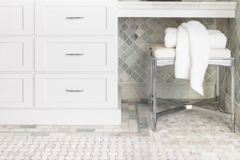 Traditional bathroom with green marble arabesque wall tile and basketweave floor tile.