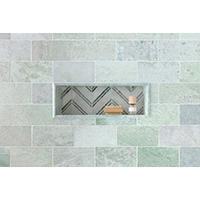 Thumbnail image of Tiled wall with recessed niche with mosaic chevron pattern as accent and trimmed in green marble profile that coordinates with subway tile on wall.