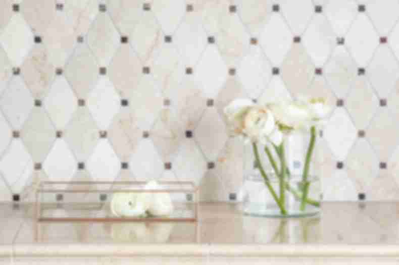 Brown and ivory marble diamond-shaped mosaic bathroom backsplash.