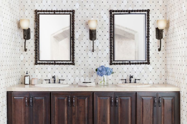 Traditional bathroom with cream and brown marble mosaic backsplash.