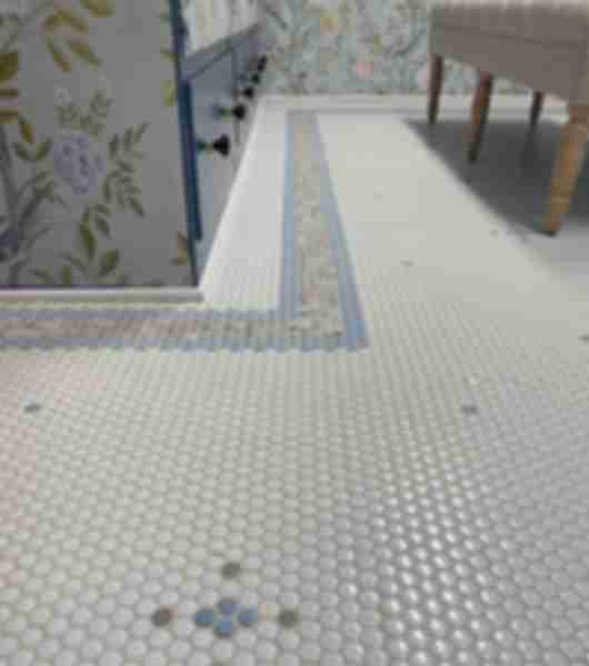 Mosaic penny round floor featuring blue, taupe and white tiles.