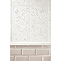 Thumbnail image of Close up image of wall tile with beveled 3x6 subway and a nature pattern stamped in white square tile. They are divided in the center by natural stone profiles.