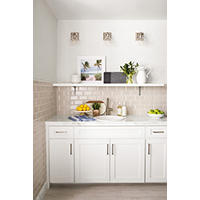 Thumbnail image of Kitchen area with tile backsplash stone profiles cap walls along with the natural stone baseboard and countertop with matching profiles alike this space has  a faux wood look tile on the floor both warm and cool neutral tones combine to make this space neutral and timeless.