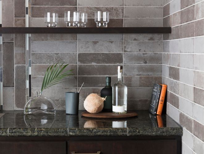Kitchen backsplash with grey brick tile and stone and glass accent tile.