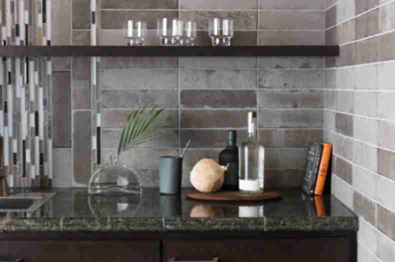Kitchen backsplash with grey brick tile and stone and glass accent tile.