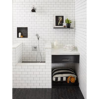 Thumbnail image of This space is a unique tiled dog washing station done in classic black and white tones but with unique shapes of black tile.  Travertine chevron pattern floor adds clean lines and sharp angles this complements the shower pan and recessed niche of a different pattern but same tone coupled with a lighter charcoal/grey element to the design. Marble caps are used on partition walls and classic white subway tile in with black grout complete the look.