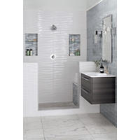 Thumbnail image of Bathroom area with walk in shower and floating vanity.  Large profile marble look tiles on floor walls are in several sizes shapes and textures.  Shower has two recessed niches with glass shelves glass accent tile that pops off white wall tile. Vanity wall is larger subway to match accent tiles darker color tone and pattern.Shower pan is marble cobble mosaic tile.