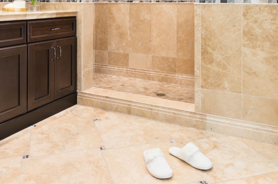 Bathroom with beige stone tile.