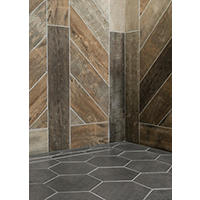 Thumbnail image of Tiled room has wall area diagonally laid and framed in a faux wood plank porcelain  tile with multi tones and rustic textures paired with ten inch hexagon shaped  porcelain floor tile in a dark linen pattern