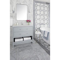 Thumbnail image of Bathroom area featuring natural marble tile in both large profiles and a mosaic to make a circular pattern looping through both wall and floor and striking out the soaker tub area this space is luxurious with clean lines soft Grays and whites simplistic lighting and mirrors extra storage under vanity.